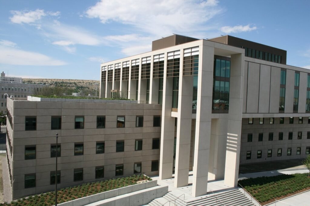 The pale stone James F. Battin Federal Courthouse in Billings, Montana, with tall columns at its entrance