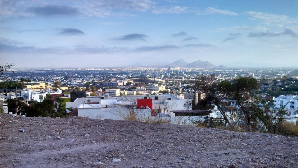 Panoramic view of Culiacán, Sinaloa, with the Tomateros baseball stadium and mountains in the distance