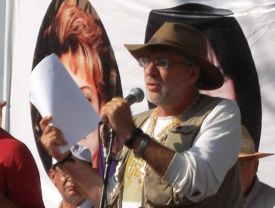 Javier Sicilia speaking at a microphone during the May 2011 peace march in Mexico City's Zócalo