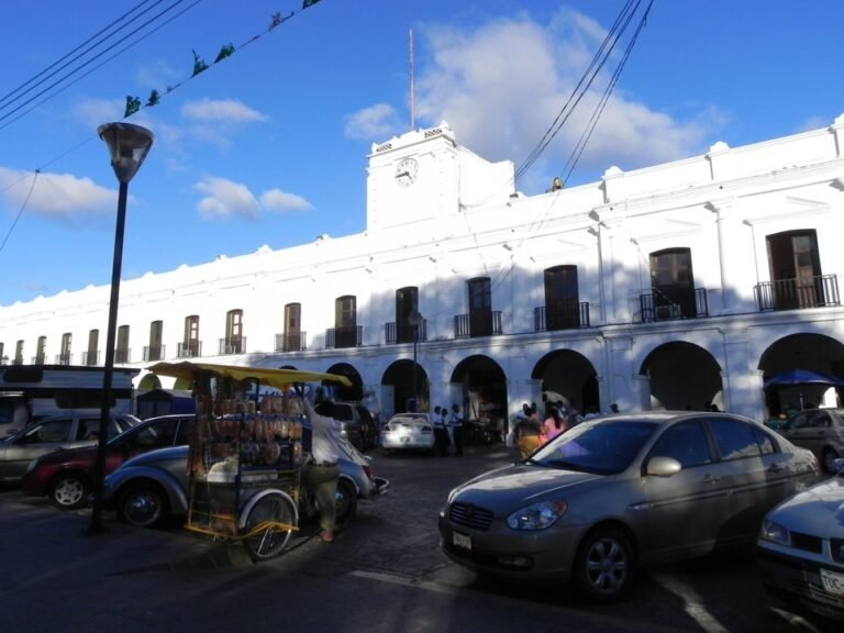 White colonial-style municipal palace with a clock tower and arcades in downtown Juchitán, Oaxaca