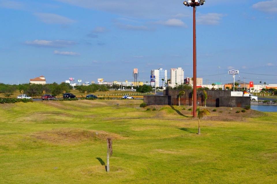 Archive panorama of Reynosa with roads, buildings and open grassland.