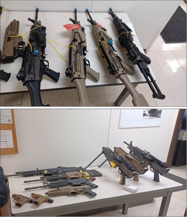 Belt-fed FN 249 rifles and other firearms seized by CBP displayed on tables