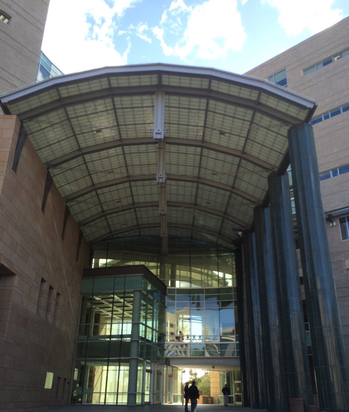 The glass-roofed entrance canopy of the federal courthouse in Tucson, Arizona, between two sandstone towers