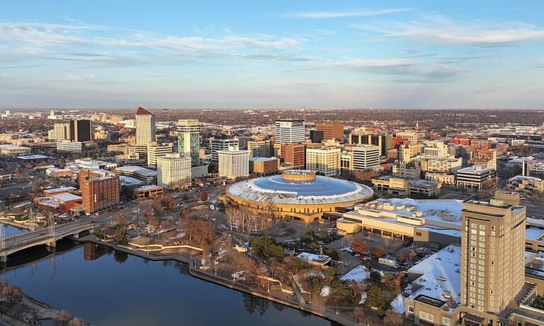 Aerial view of downtown Wichita, Kansas, with the domed Century II center beside the Arkansas River