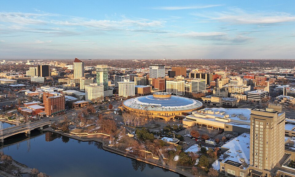 Aerial view of downtown Wichita, Kansas, with the domed Century II center beside the Arkansas River
