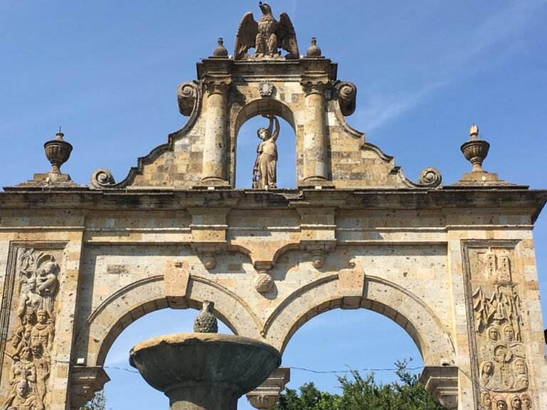 The stone Arches of Zapopan, a colonial-style gateway topped by an eagle sculpture, in Zapopan, Jalisco