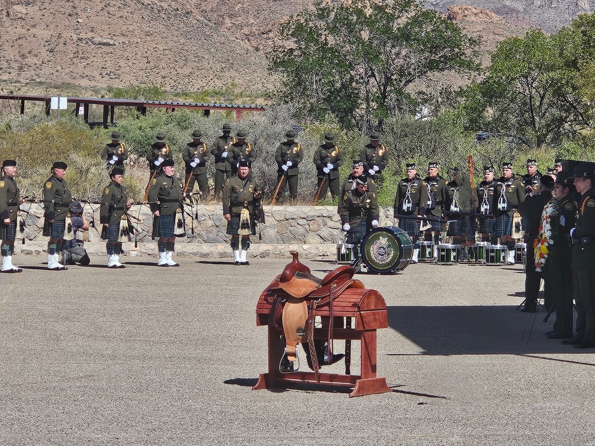 U.S. Border Patrol agents in green uniforms and a pipe and drum band stand at a ceremony in El Paso, Texas