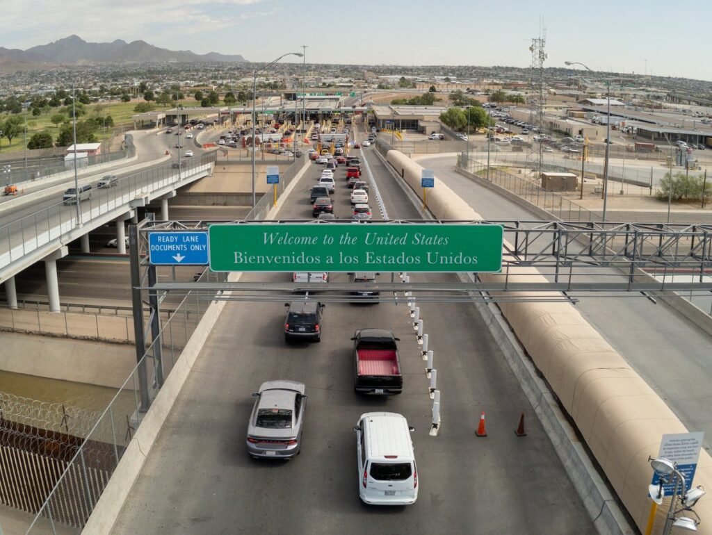 Aerial view of vehicle lanes under a 'Welcome to the United States' sign at the Bridge of the Americas port of entry in El Paso, Texas