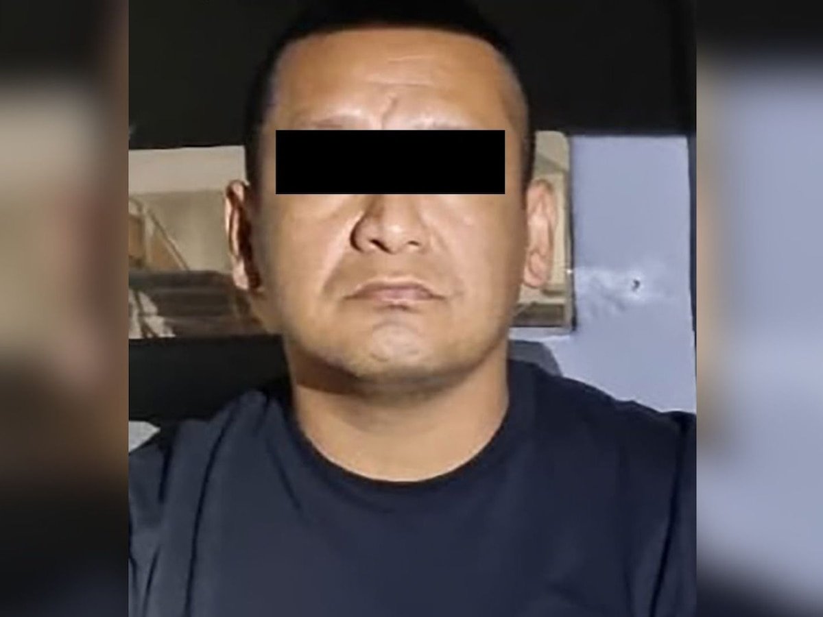Iván Cazarín Molina, “El Tanque,” eyes blacked out, in a dark navy T-shirt, photographed after his arrest