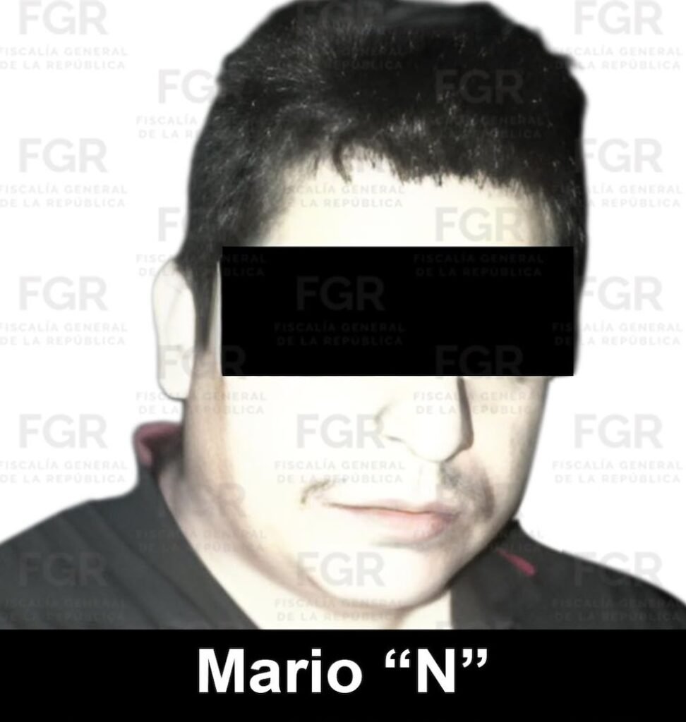 FGR handout photo of a dark-haired man in a dark shirt with a black bar over his eyes, FGR watermarks behind him and the label 'Mario “N”'