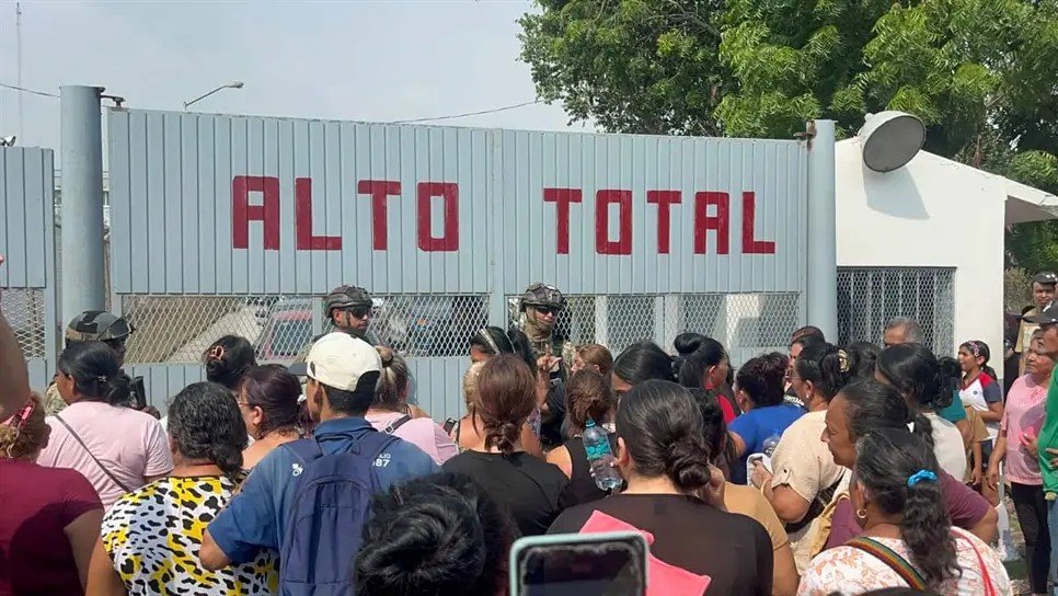Relatives of inmates gather outside the 'Alto Total' gate of El Castillo prison in Mazatlán seeking information after the riot