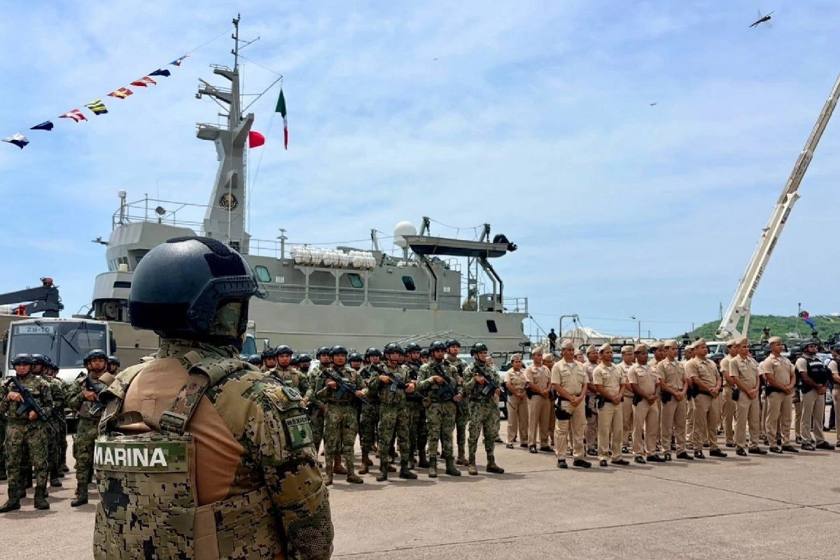 Mexican Navy marines in formation on a dock in front of a Navy ship in Mazatlán